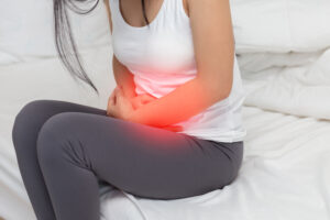 Stomachache in young Asian woman